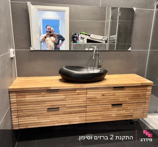 חדר אמבטיה עם כיור וברז, אדם במראה